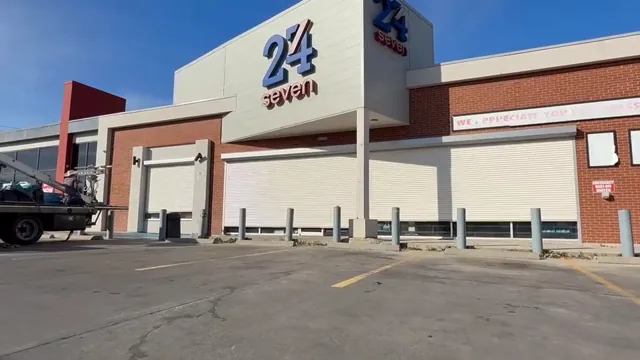 Across a brick retail frontage. Rolling shutter installation
