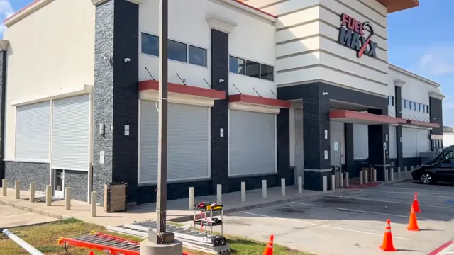 A two-story storefront. Rolling shutter installation